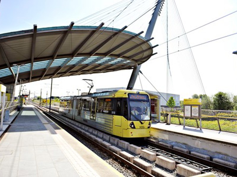 Image of a yellow train at a platform.