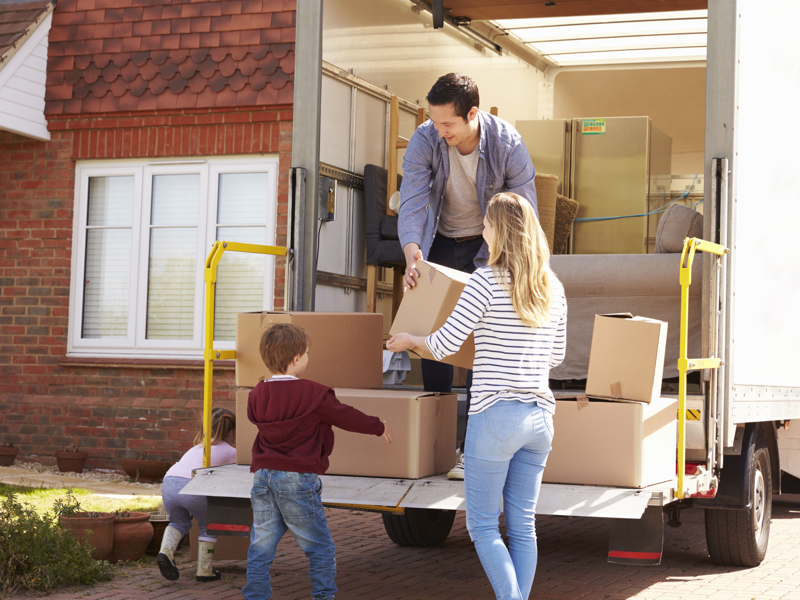 image of a family removing boxes from a removal van.