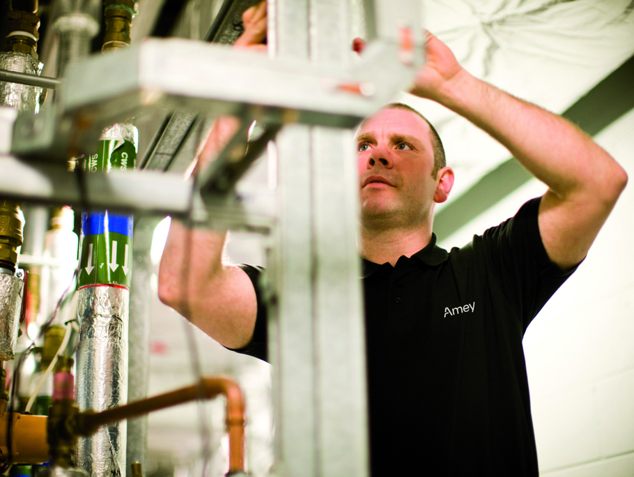 Image of Amey employee working on flow pipes