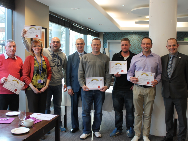  group of people holding 'employee skills' certificates.