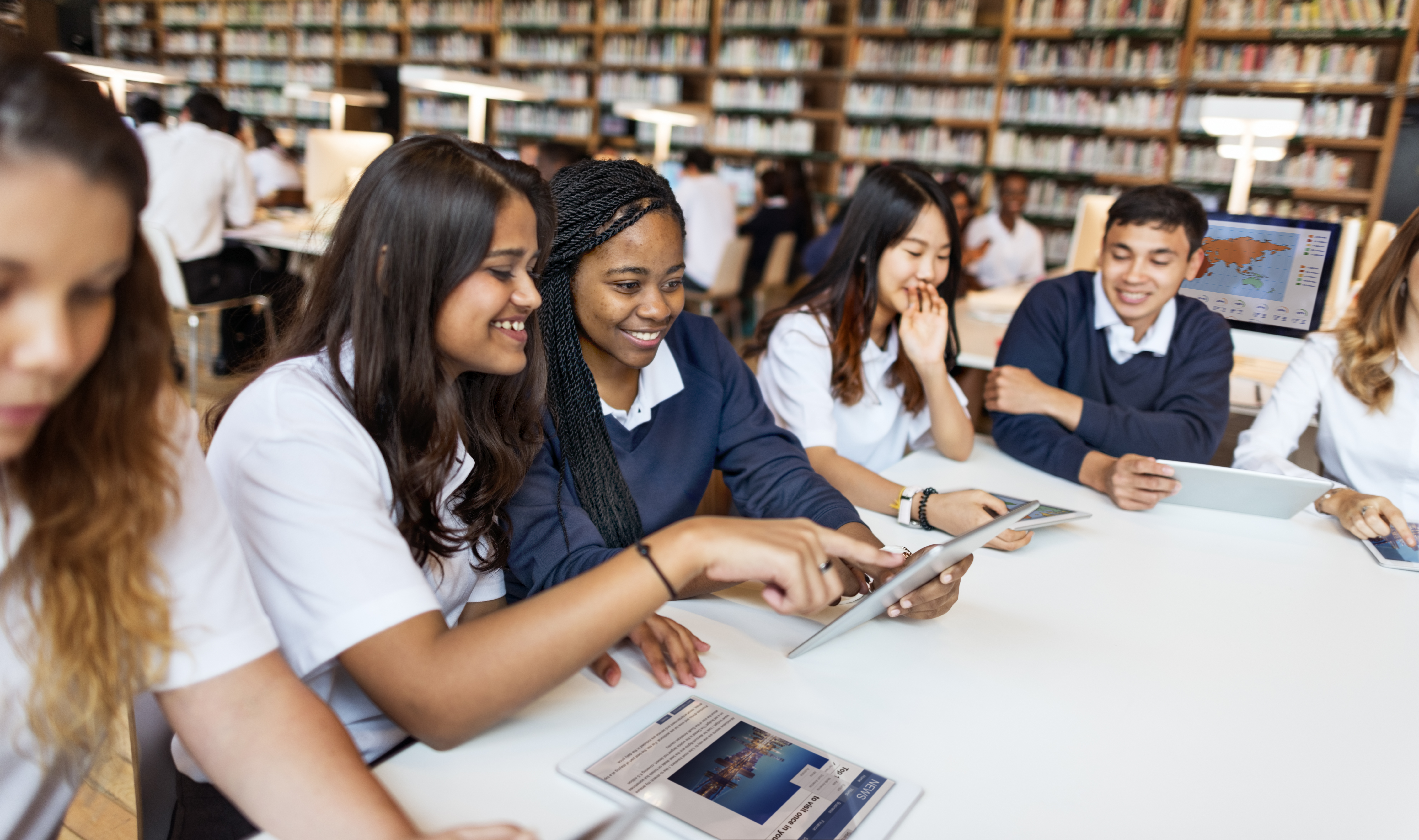 Group of school pupils working together around a desk