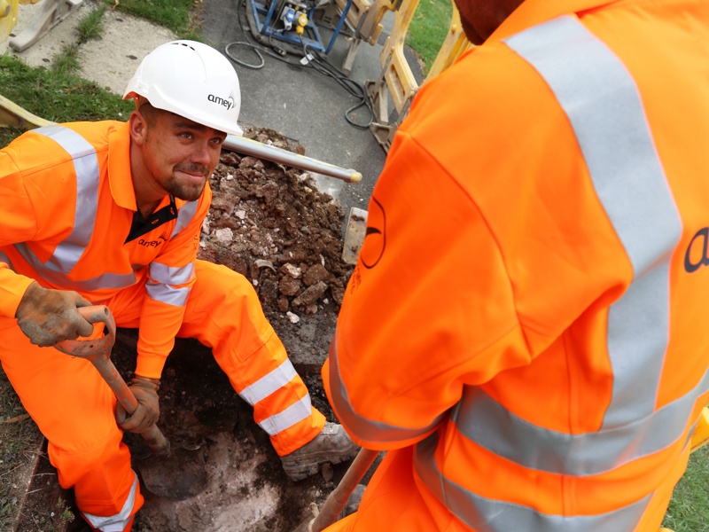Image of two Amey employee's digging a hole.