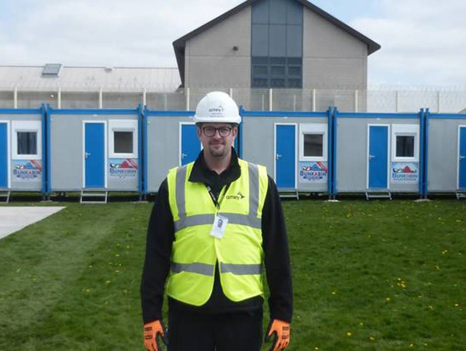 Amey employee standing in the centre of multiple porta cabins