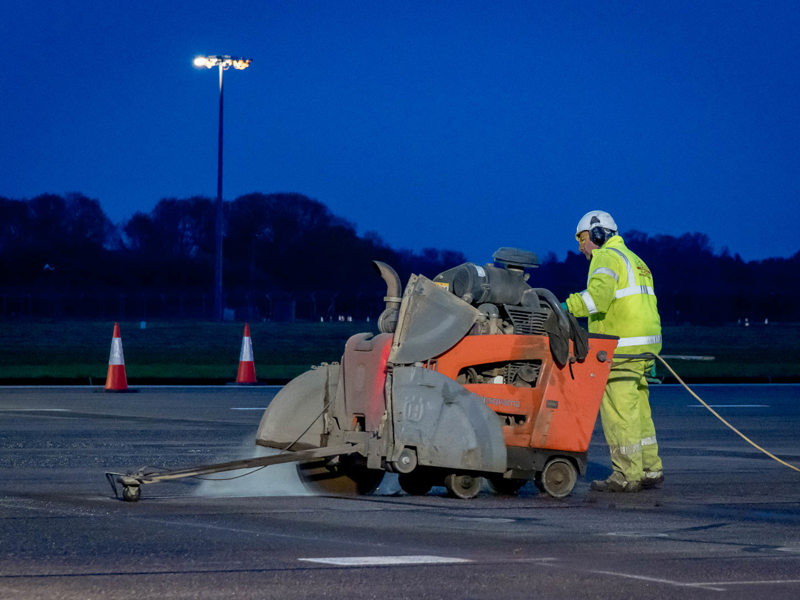 Amey worker operating machinery, carry out phase 2 of runway
