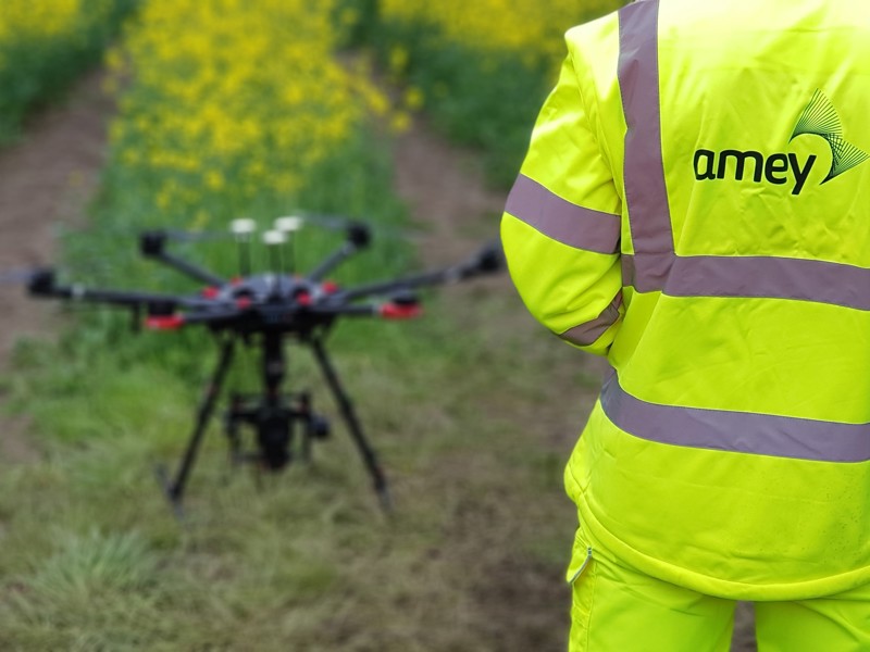 Image of a person in Amey PPE stood in front of a drone.