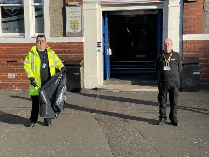 Image of Amey employees litter picking in front of Drummond Community highschool.