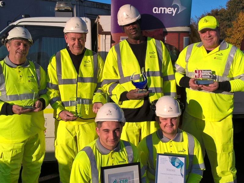 Six Amey employees in PPE, holding awards.