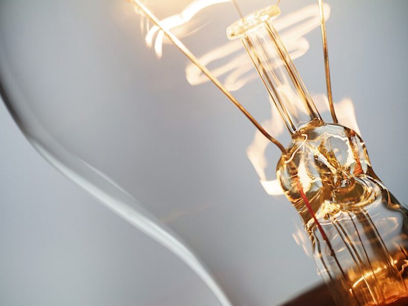 Up close image of a light bulb filament.
