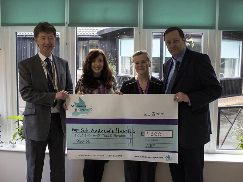 Amey employees holding a cheque for funds raised for St Andrew's Hospice.