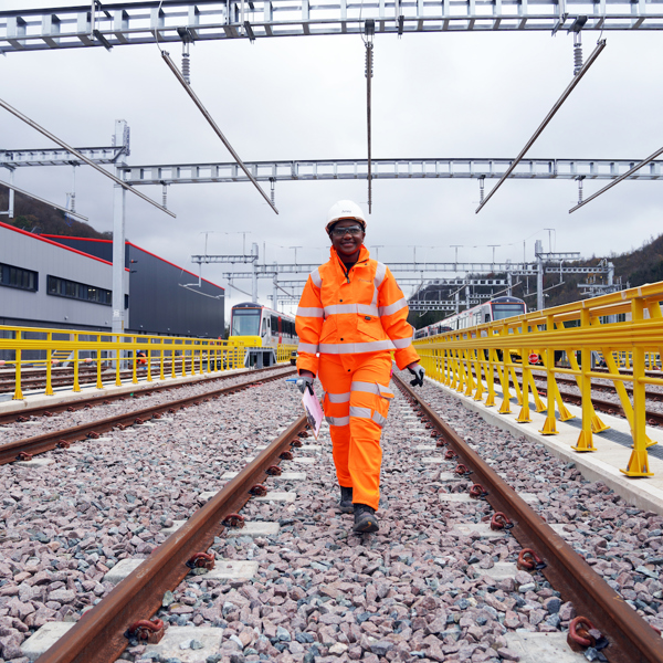 A woman in PPE on a rail track