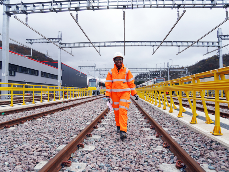 A woman in PPE on a rail track