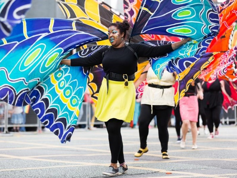 Image of a woman at a carnival dressed as a butterfly.