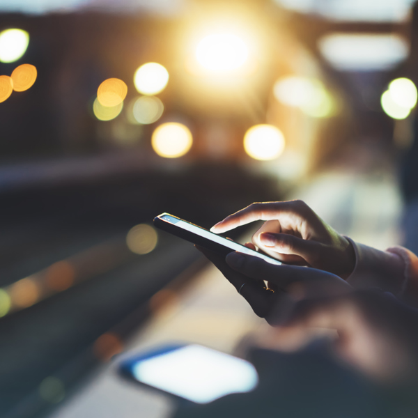 man on his phone at a train platform