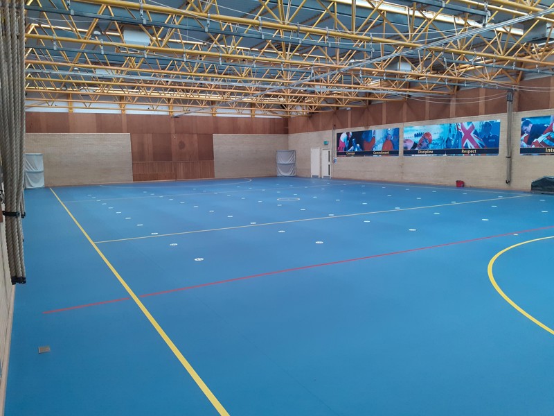 Image of a gym that has just had a new floor installed.