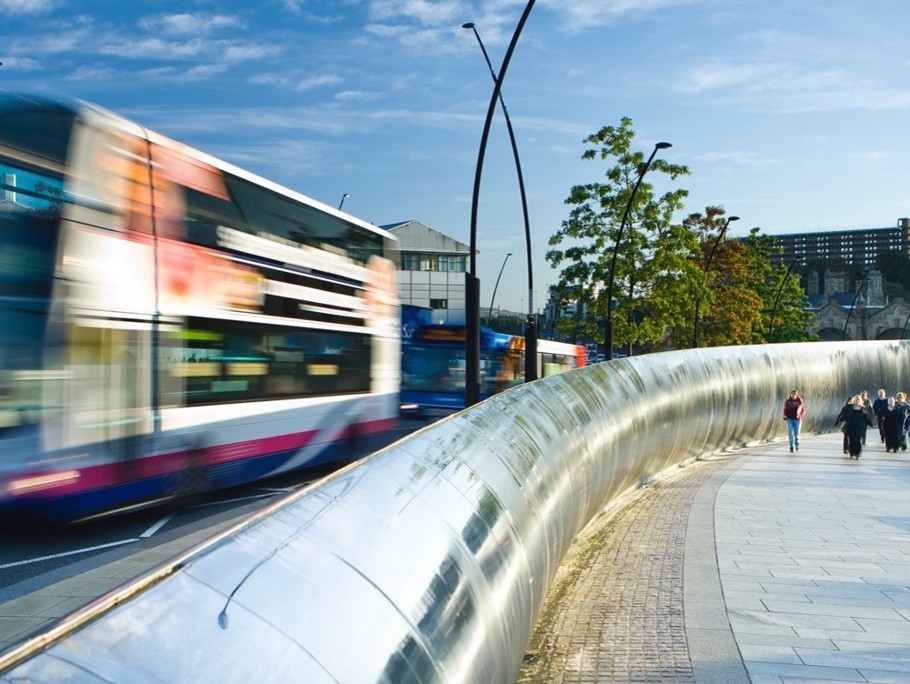 Image of a blurred bus in a city centre