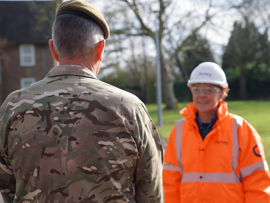 A military man stood in front of an Amey personnel.