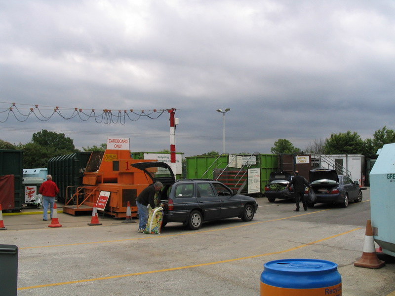 Cars parked at a recycling centre.