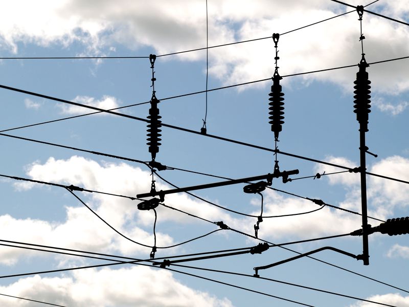 Image of overhead lines with clouds in the background