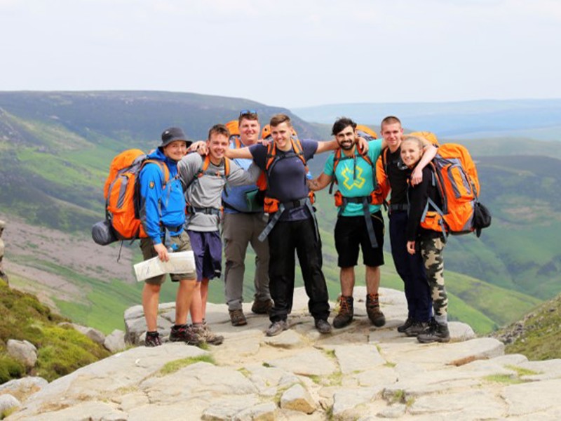 Image of a group of people on top of a mountain.