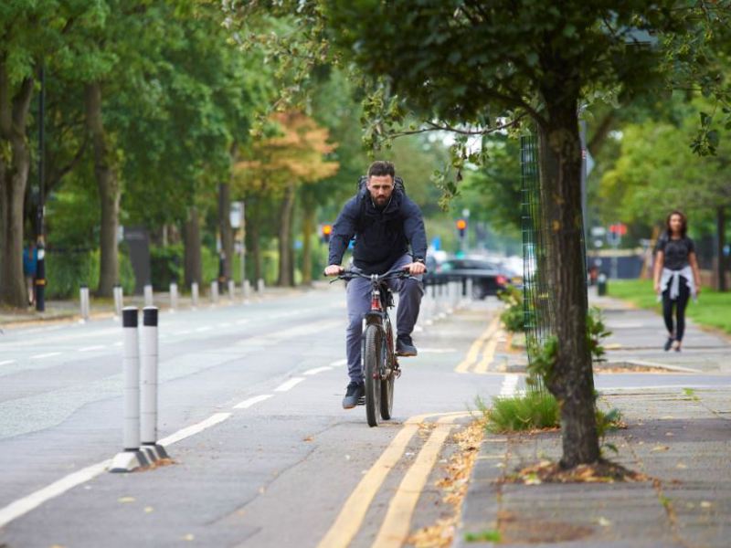 Image of a man cycling up a cycle path.