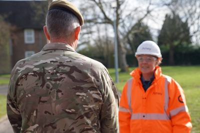 military personnel and Amey employee in PPE.