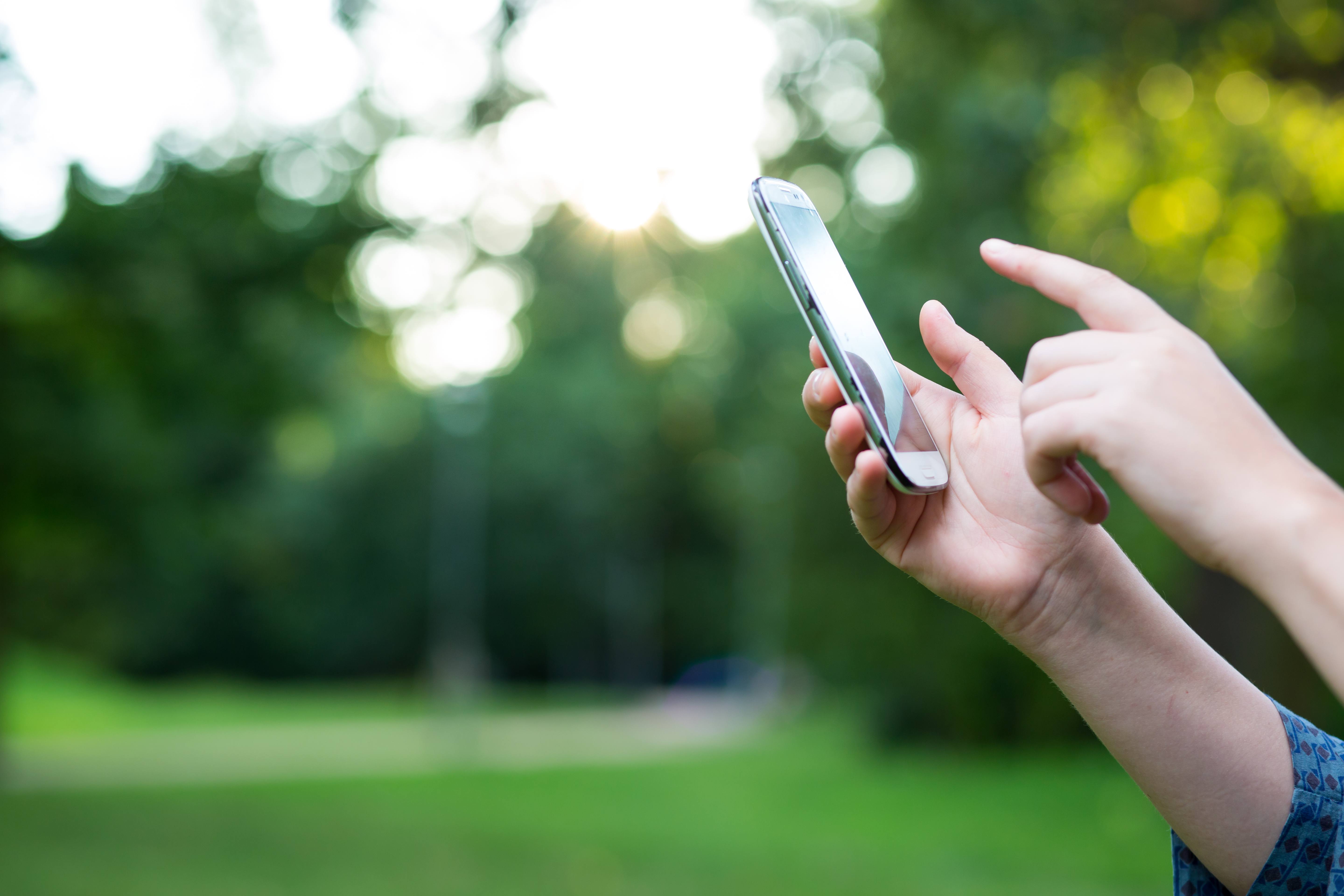 Image of a person using their mobile phone