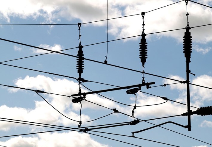 Image of overhead lines with clouds in the background