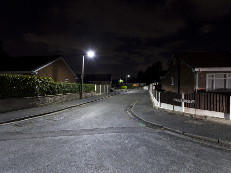 Image of a street in the dark, light by street lighting,