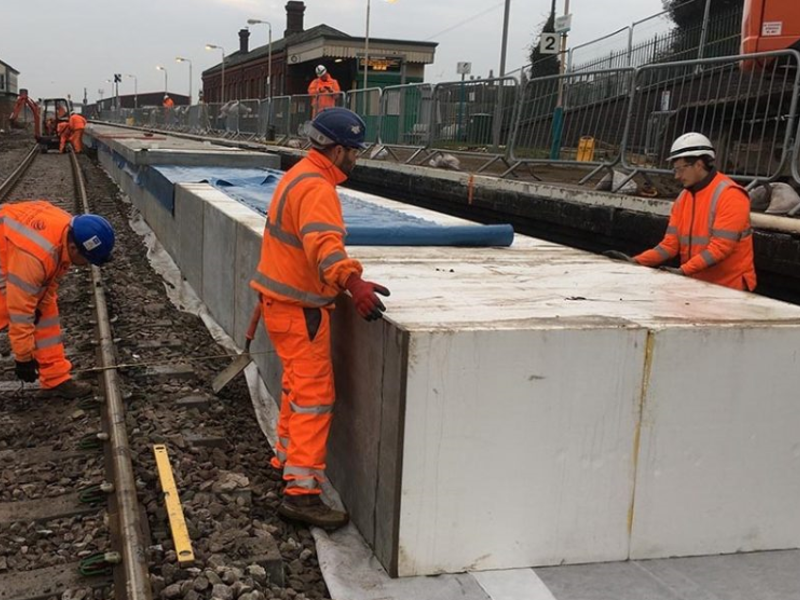 Image of Amey employees in PPE, carrying out work on a rail track.