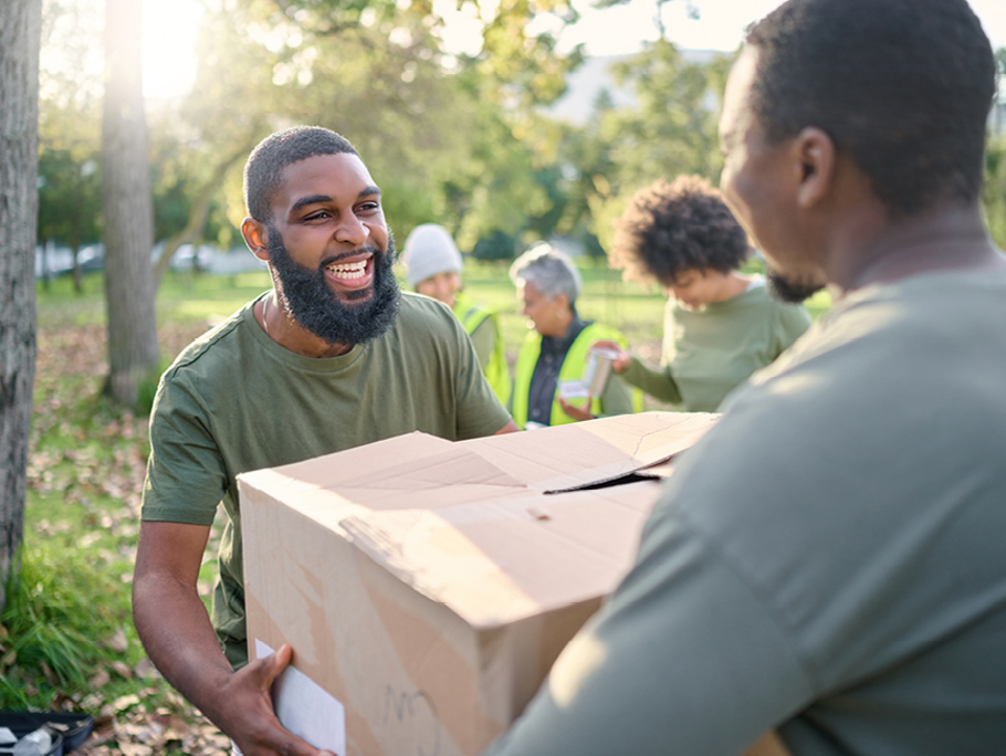 Two men passing a box