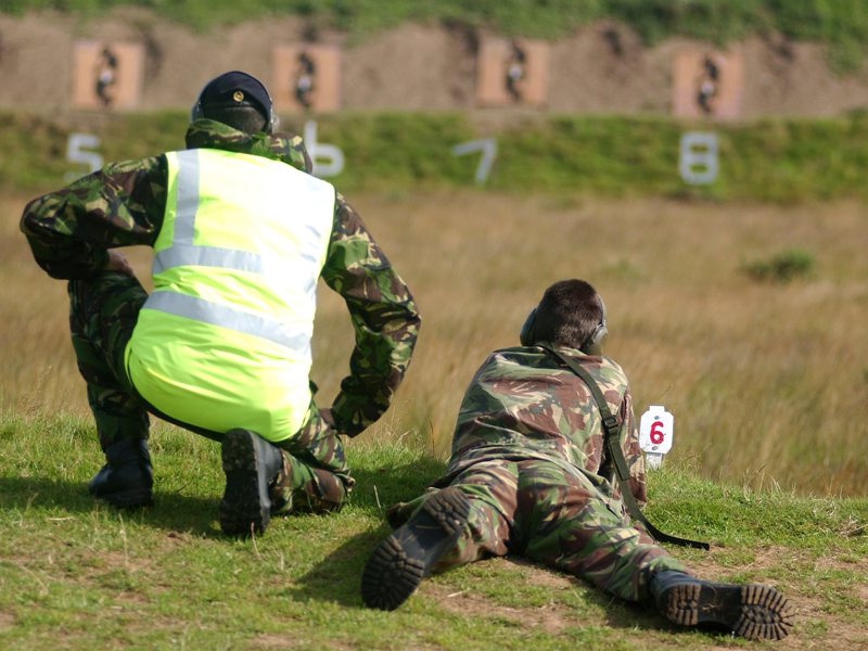Image of two military personnel at a firing range.