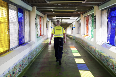 An Amey employee with their back towards us, walking