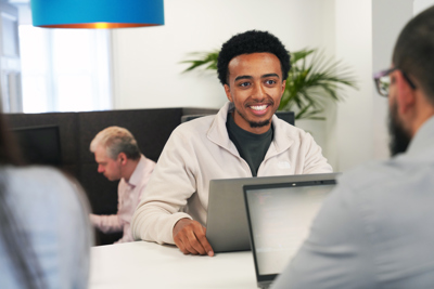 a man at a desk in front of their laptop