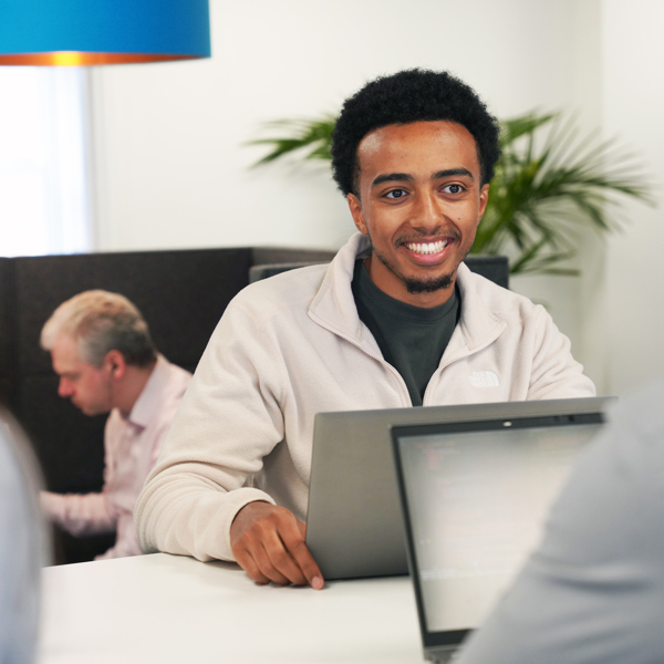 a man at a desk in front of their laptop