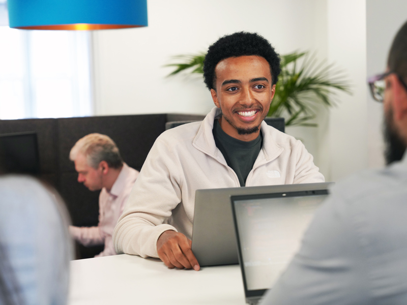 a man at a desk in front of their laptop