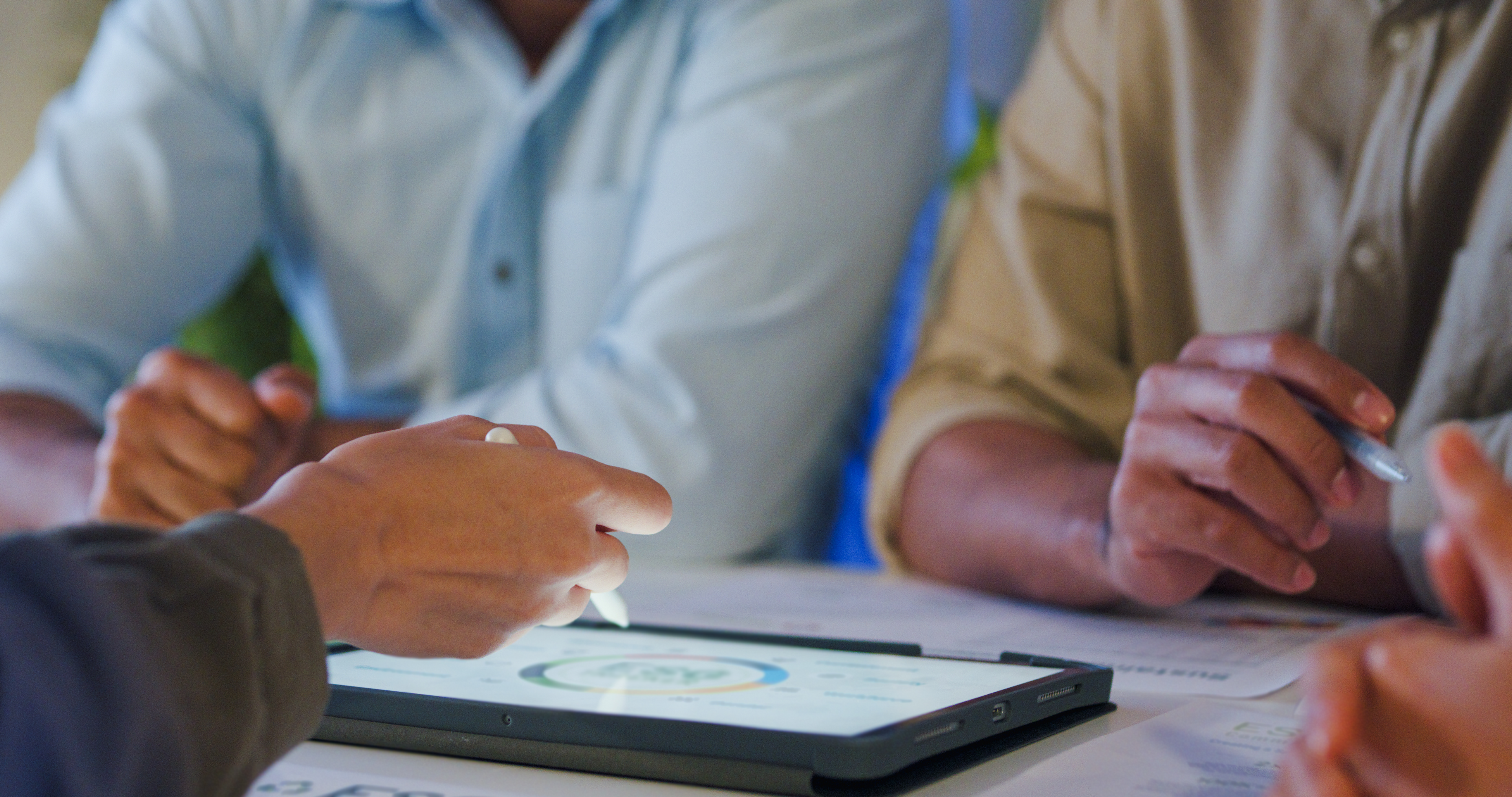 Image of team working on tablet