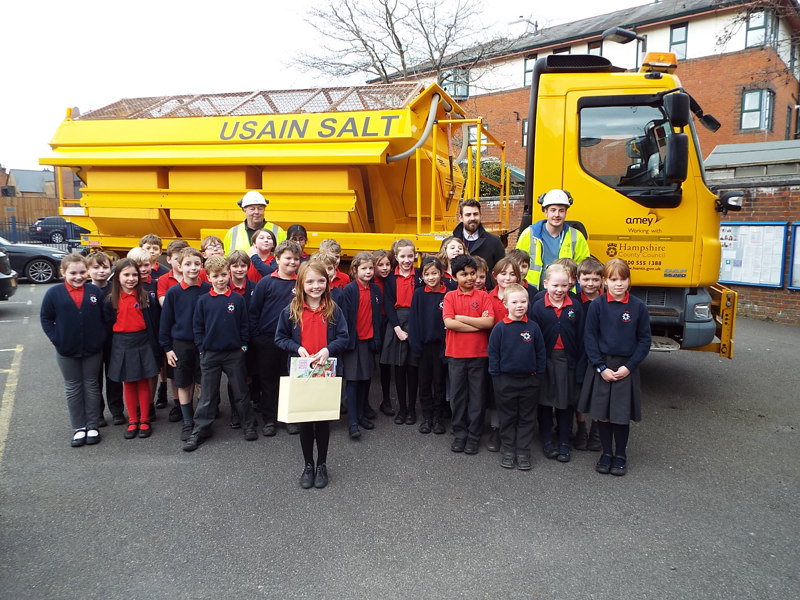 Image of school children in front of a gritter.
