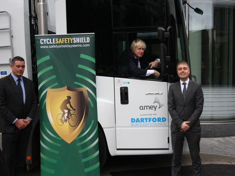 Image of Amey Dartford vehicle, with a man driving and two men in suits stood outside, with a cycle safety banner